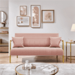 Close-up of pink fabric and cushions on small sofa