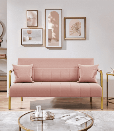 Close-up of pink fabric and cushions on small sofa