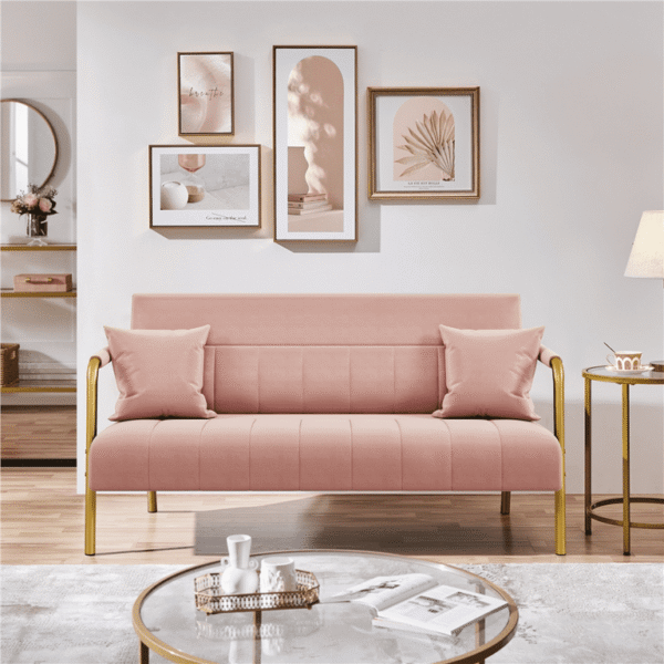 Close-up of pink fabric and cushions on small sofa