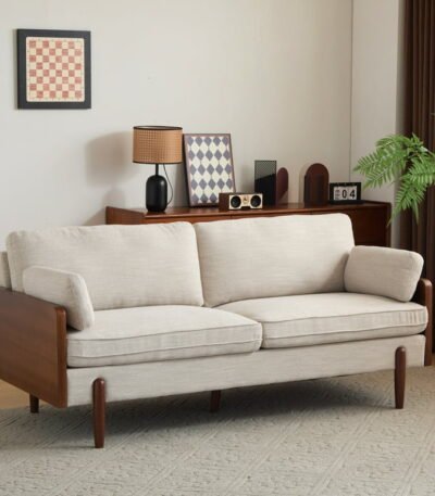 Slim arm beige sofa styled with rug and center table